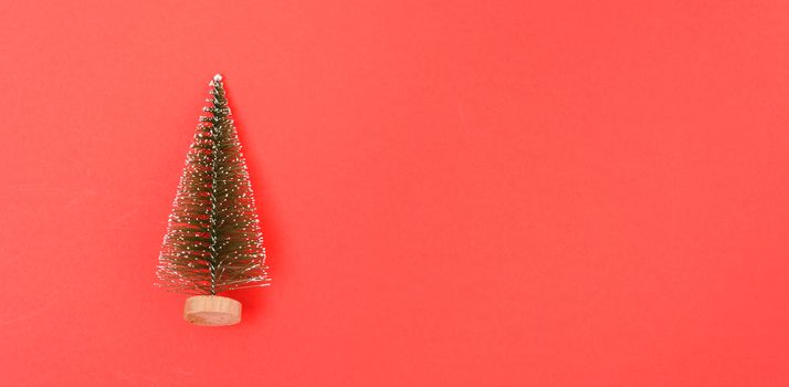 Christmas holiday theme with small Christmas trees decorated on red background. Merry Christmas concept. With Copy space for text