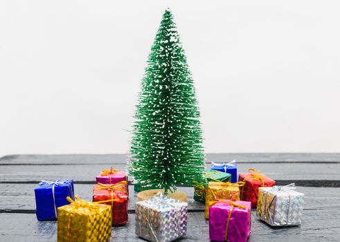 Christmas composition decorations, minimal green fir tree branches with snow and gift boxs on white background. Merry Christmas concept. Copy space for text