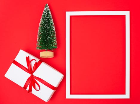 Happy New Year and Christmas 2020 day, top view Xmas white gift boxes & fir tree on red background with copy space for your text