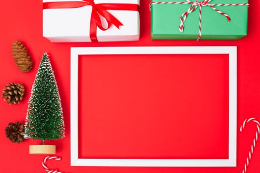 Happy New Year and Christmas 2020 day, top view Xmas white gift boxes & fir tree on red background with copy space for your text