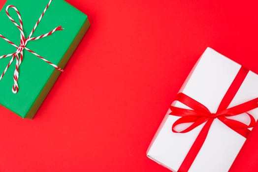 Happy New Year and Christmas 2020 day, top view Xmas white and green gift boxes on red background with copy space for your text