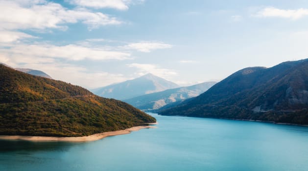 autumn mountain landscape with green forest and lake and sky and clouds in Georgia