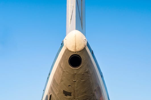 fragment of the plane of an old airliner against a blue sky isolated