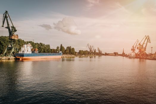 Big container cranes in the port of Gdansk, Poland in different scenery