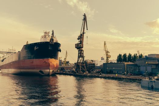 Big container cranes in the port of Gdansk, Poland in different scenery