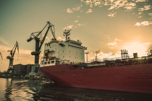 Big container cranes in the port of Gdansk, Poland in different scenery