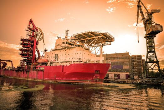 Big container cranes in the port of Gdansk, Poland in different scenery