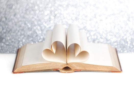 Book with opened pages and shape of heart love reading concept