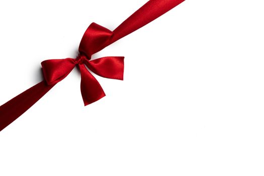 Elegant satin red ribbon bow isolated on white background