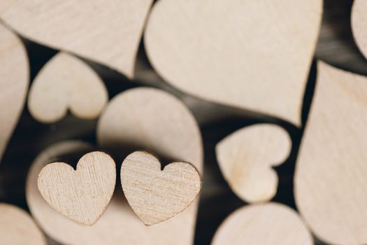 Many wooden colorless hearts background