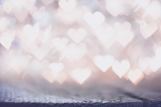 Glowing beautiful golden bokeh lights background. Vintage style. Love Valentine's Day concept.