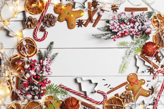 Christmas flat lay background with traditional gingerbread cookies dried orange cinnamon on wood , copy space for text