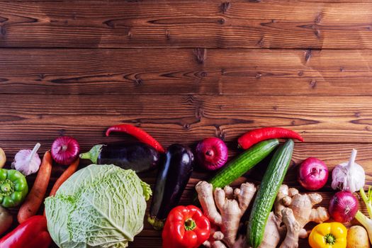 Harvest of many various colorful vegetables on wooden background