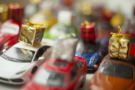 Traffic jam of toy cars carrying holiday gifts or black friday sale purchase