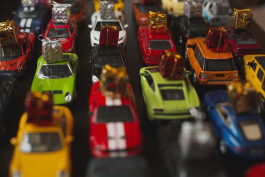 Traffic jam of toy cars carrying holiday gifts or black friday sale purchase