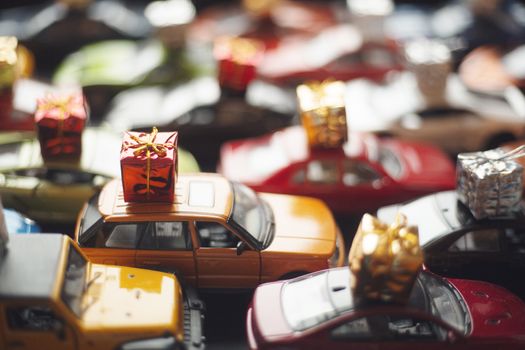 Traffic jam of toy cars carrying holiday gifts or black friday sale purchase