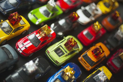 Traffic jam of toy cars carrying holiday gifts or black friday sale purchase