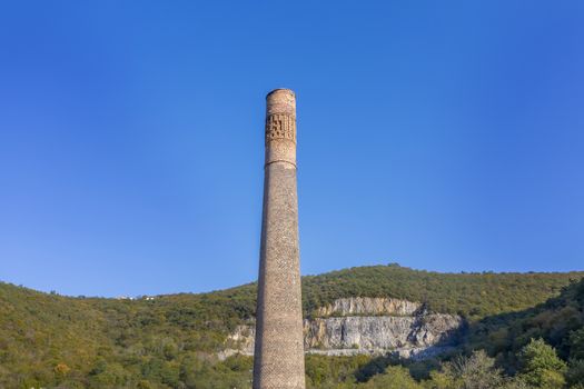 tall old factory chimney made of brown bricks, an aerial view