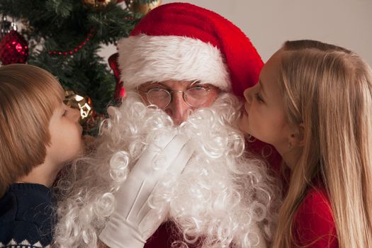 Two Children whispering to Santa Claus ear Suggesting desires