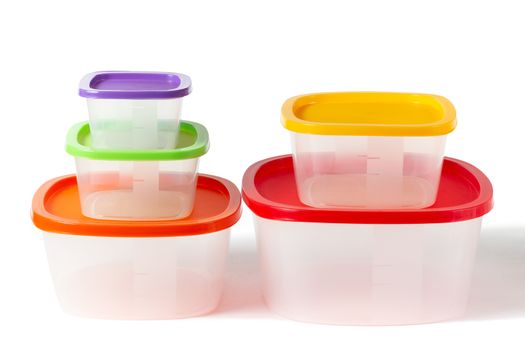 Set of plastic boxes with multi-colored lids. Isolated on a white background with clipping paths with shadow and without shadow.