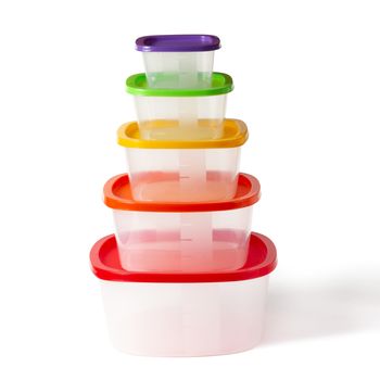 Set of plastic boxes with multi-colored lids. Isolated on a white background with clipping paths with shadow and without shadow.