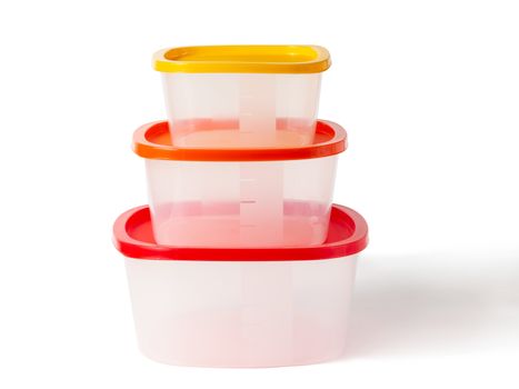 Set of plastic boxes with multi-colored lids. Isolated on a white background with clipping paths with shadow and without shadow.