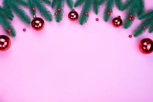 Christmas holidays composition, top view of red Christmas decorations on pink background with copy space for text. Flat lay, winter, postcard template, new year concept.
