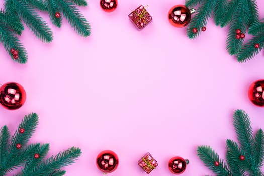 Christmas holidays composition, top view of red Christmas decorations on pink background with copy space for text. Flat lay, winter, postcard template, new year concept.