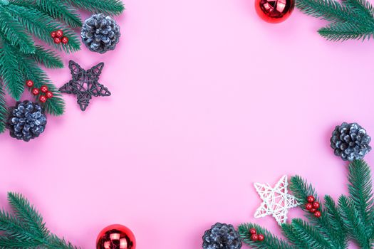 Christmas holidays composition, top view of red Christmas decorations on pink background with copy space for text. Flat lay, winter, postcard template, new year concept.