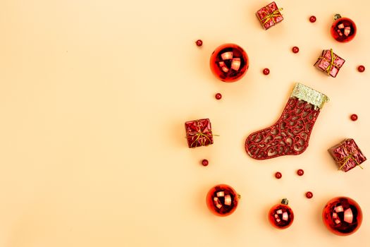 Christmas holidays composition, top view of red Christmas decorations on yellow background with copy space for text. Flat lay, winter, postcard template, new year concept.