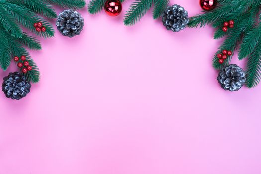 Christmas holidays composition, top view of red Christmas decorations on pink background with copy space for text. Flat lay, winter, postcard template, new year concept.
