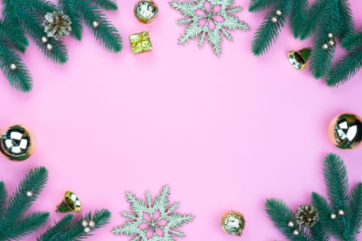 Christmas holidays composition, top view of gold Christmas decorations on pink background with copy space for text. Flat lay, winter, postcard template, new year concept.