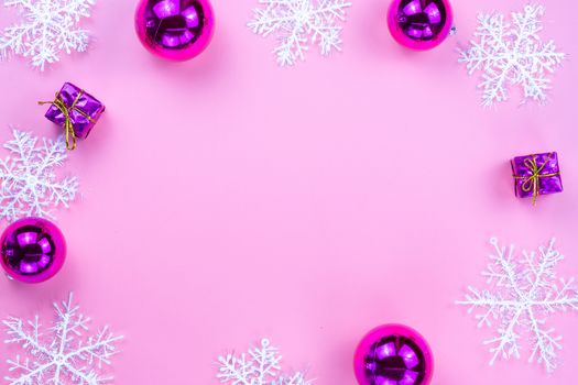 Christmas holidays composition, top view of pink Christmas decorations on pink background with copy space for text. Flat lay, winter, postcard template, new year concept.