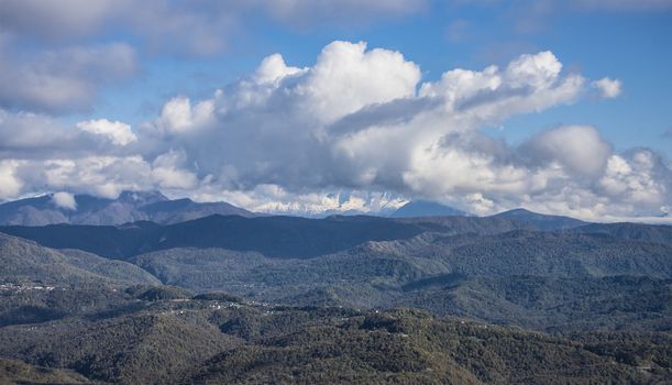 View of the Caucasus mountains from the observation deck from mount Akhun, near the city of Sochi, Russia. 2 November 2019.