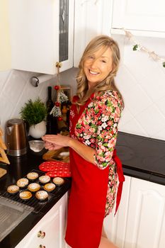 A woman cooking sweet fruit pies in the kitchen