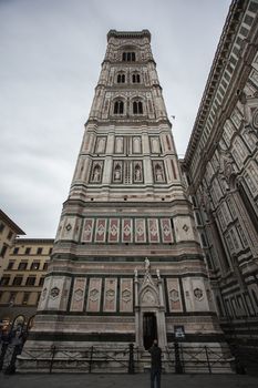 Detail of the bell tower of the Duomo of Florence shot on a cloudy day with the light that enhances the colors