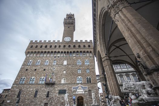 Piazza della Signoria in Florence full of tourists who visit it during a Winter Day