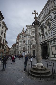 Detail of the Piazza del Duomo in Florence with tourists visiting it on a cloudy day with the light that enhances the colors