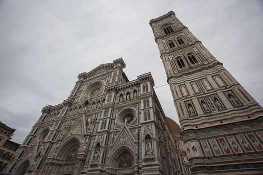 View of the Front Facade of the Duomo of Florence shot on a cloudy day with the light that enhances the colors
