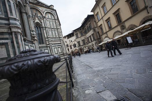 Detail of the Piazza del Duomo in Florence with tourists visiting it on a cloudy day with the light that enhances the colors