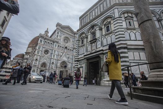 Detail of the Piazza del Duomo in Florence with tourists visiting it on a cloudy day with the light that enhances the colors