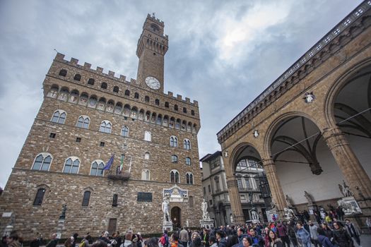 Piazza della Signoria in Florence full of tourists who visit it during a Winter Day