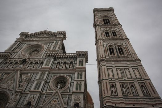 Detail of the bell tower of the Duomo of Florence shot on a cloudy day with the light that enhances the colors