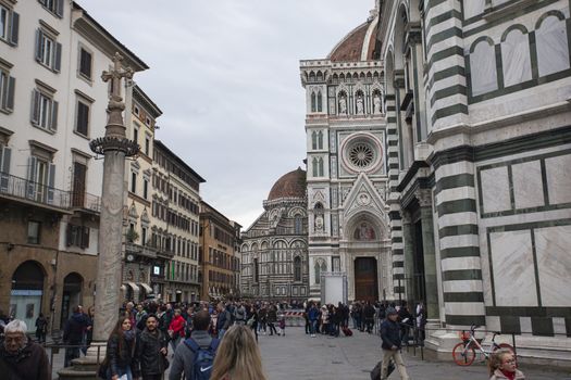 Detail of the Piazza del Duomo in Florence with tourists visiting it on a cloudy day with the light that enhances the colors