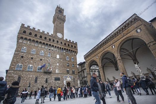 Piazza della Signoria in Florence full of tourists who visit it during a Winter Day