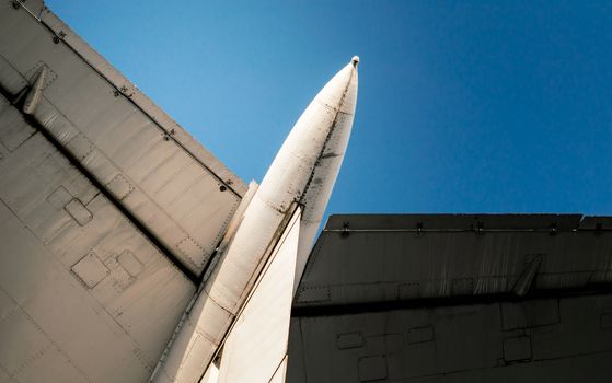 background wings of a large soviet airliner against a blue sky isolated close up
