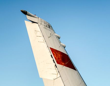background wing of a large soviet airliner against a blue sky isolated close up