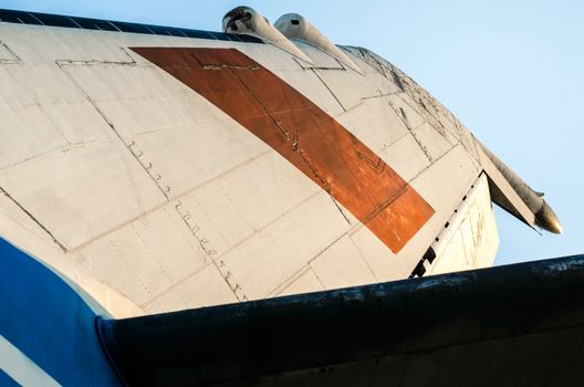 background wings of a large soviet airliner against a blue sky isolated close up