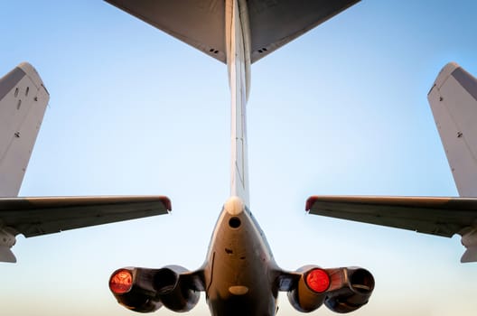 wings and turbines of a large high airliner against a blue sky