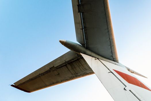 background wings of a large soviet airliner against a blue sky isolated close up